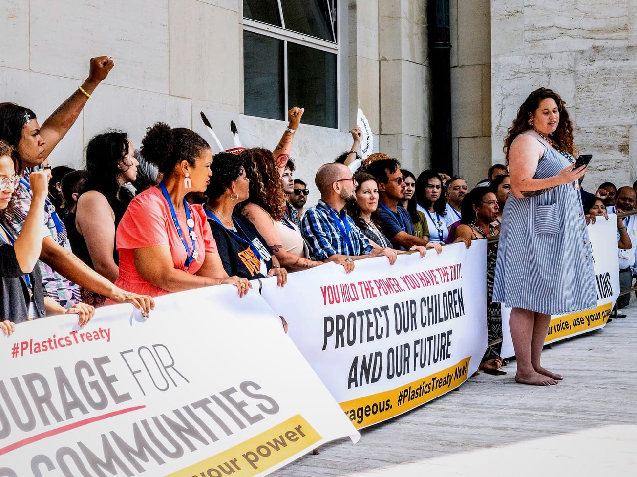 Heni Unwin, a Māori marine scientist with the Aotearoa Plastic Pollution Alliance, speaks at a rally outside the U.N.'s Palais des Nations in Geneva during the plastic treaty talks.