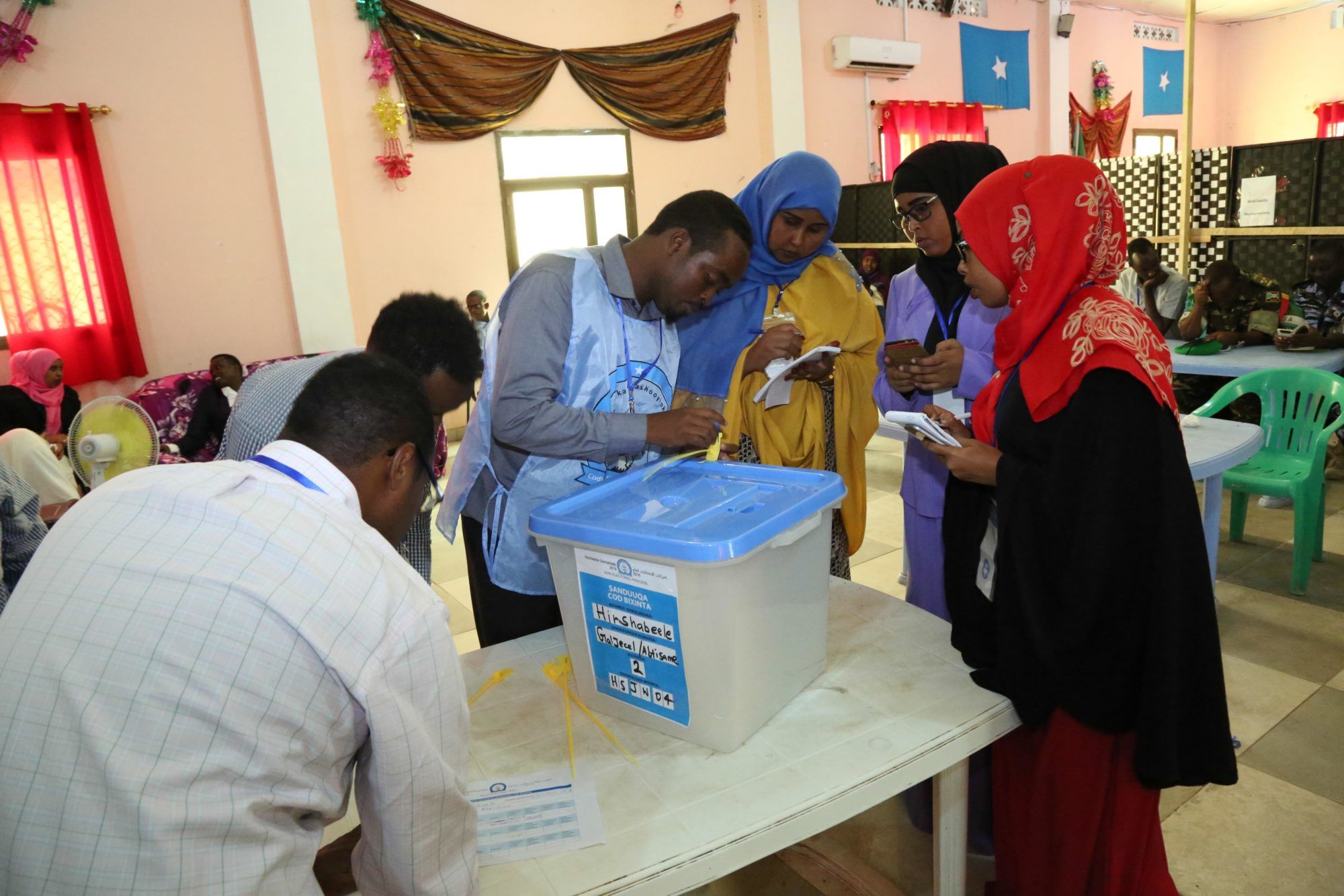 Electoral officials seal the ballot box during a Somali vote.