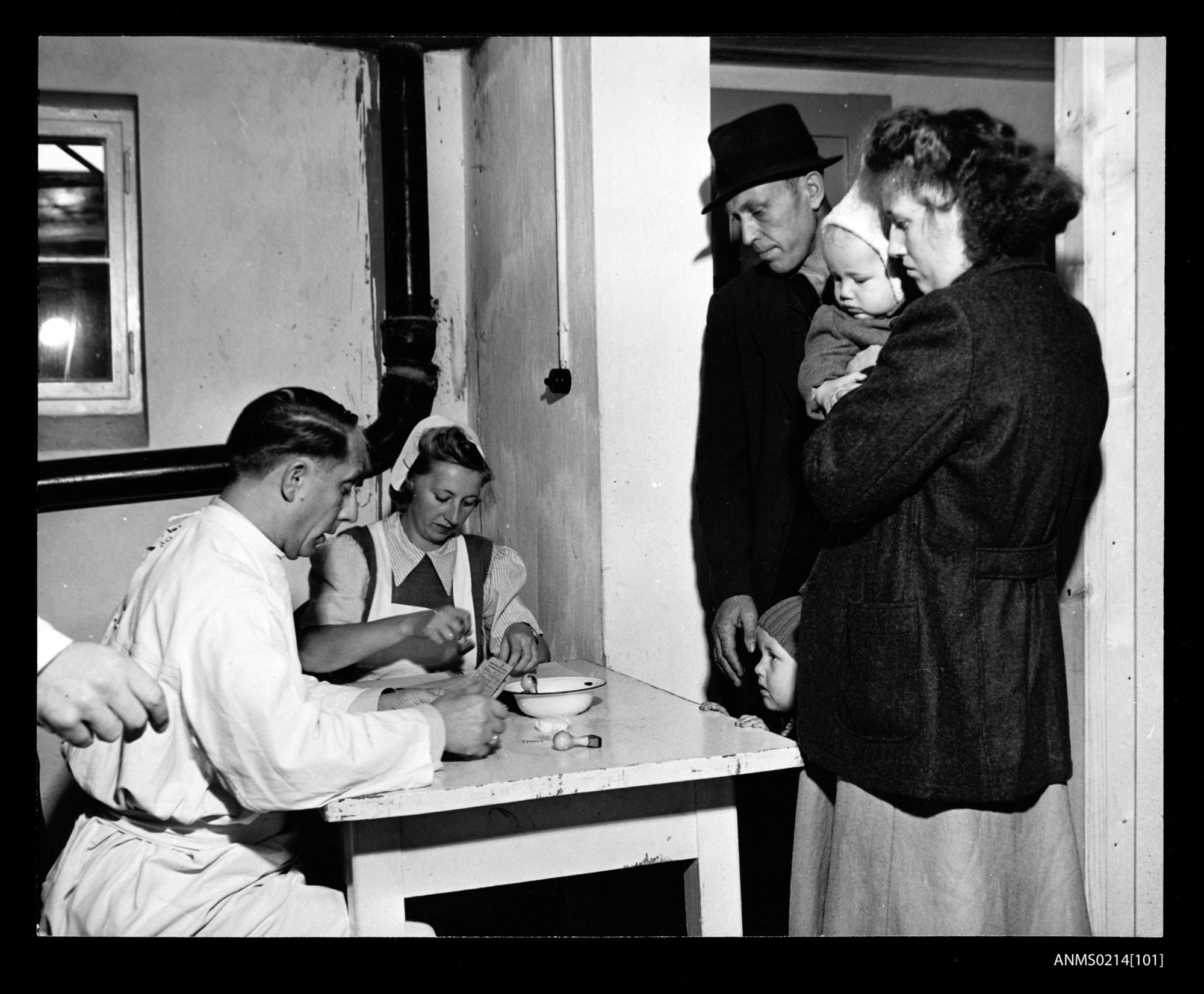 A family in Lesum, Germany takes a medical exam en route to Australia in 1951.