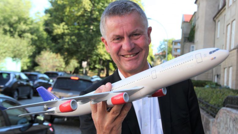 Erik Solheim holds a toy airplane